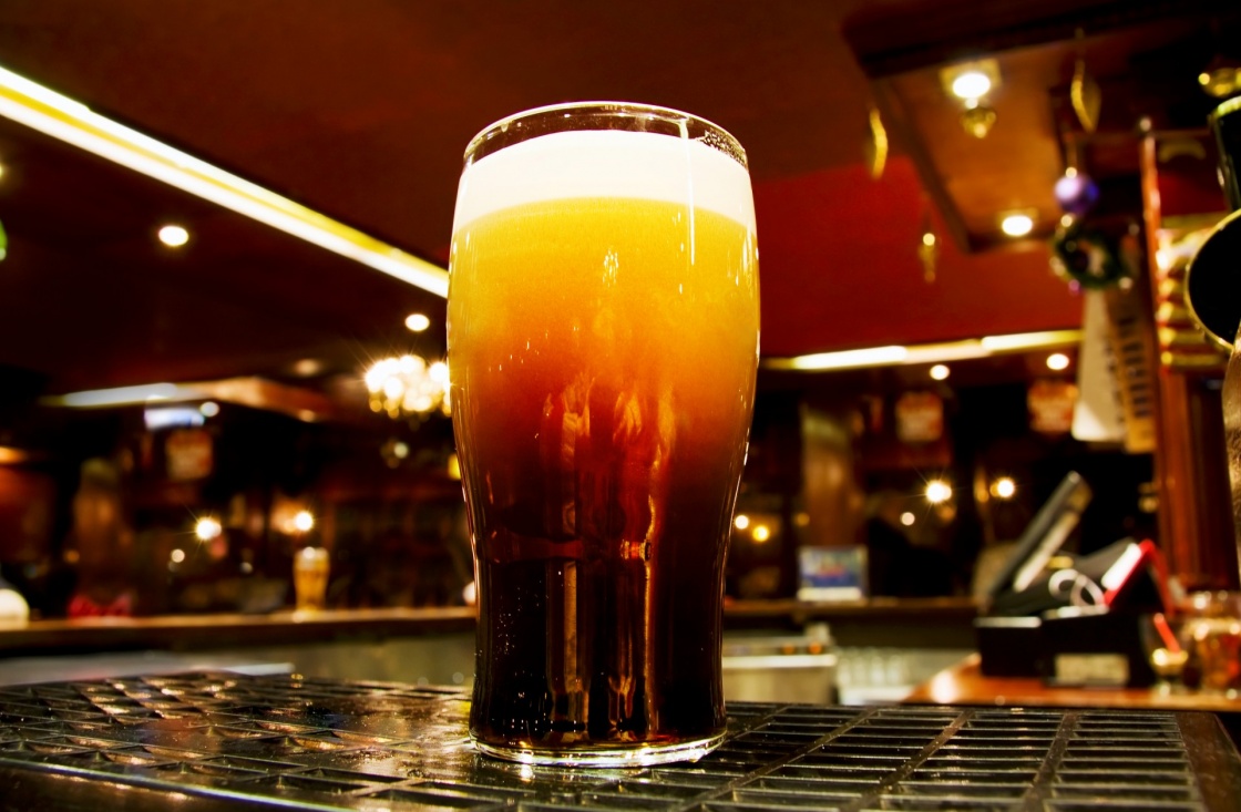 Celebrating Saint Patrick - Irish black beer shot inside a Dublin pub.